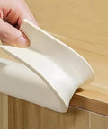 Soft Auto Adhesive Furniture Corner Protector For Edges Baby Proof Corner Guard being installed on a wooden table edge.