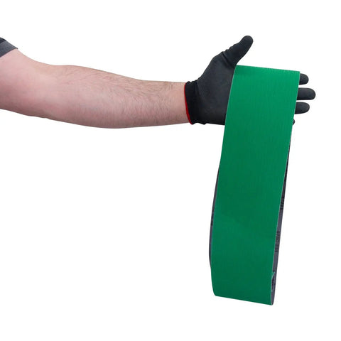 Gloved hand holding Beast Mode Ceramic Sanding Belts For Metal Grinding 4 By 36 Inch Set With 120 180 220 Grits