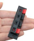 4 Pack Large Size Spring Push Speaker Terminal Block For No Fuss Wiring held in hand, showing red and black connectors.