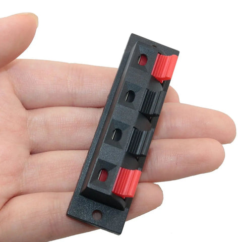 4 Pack Large Size Spring Push Speaker Terminal Block For No Fuss Wiring held in hand, showing red and black connectors.