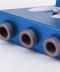 Close-up view of the Straight Shooting Aluminum Pocket Hole Drill Guide Dead On woodworking jig in blue showing drill holes.