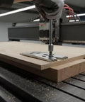 Heavy Duty Stainless Steel Panel Clamping Fixture For CNC Woodworking positioned on wood piece, adjusting serrated ends.