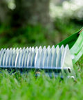 Side view of 15 Inch Adjustable Self Cleaning Thatch Rake With Hardwood Handle For Lawn Care Curved Tines For Clearing Dead Grass Clippings