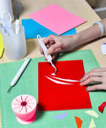 Using a hook tool from Vinyl Weeding Tools Set for Crafting and Diy Projects on red vinyl with colorful papers