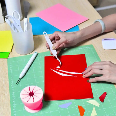 Using a hook tool from Vinyl Weeding Tools Set for Crafting and Diy Projects on red vinyl with colorful papers