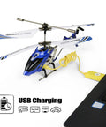 S107 S107G Phantom 3.5 Channel Mini RC Helicopter With Gyro Blue charging via USB cable next to a laptop, ready for use.