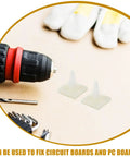 Self Adhesive PCB Standoffs With Hella Secure Insulated Foot Pads For Circuit Boards And Motherboards Built Damn Tough For Stable Electronic Component Mounting And Nitty Gritty DIY Electronics Projects Rock Solid Spacer Support System next to a drill and screws