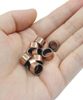 Hand holding 10 Piece Oilless Sleeve Bearings Set With 8mm Bore 10mm OD And 6mm Length Wrapped Bushings Bronze Sintered Coated