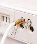 F Type Terminator Caps 5 Pack With 75 Ohm Resistor For Unused Coax Ports on wall plate next to cable connector.
