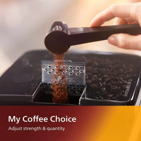 Ready To Roll Black Fully Automatic Espresso Machine With Zero Hassle Bean To Cup Brewing And Slick Touch Panel For Iced Coffee Or Five Daily Grind Favorites Plus Quick Clean Lattego Milk Frother pouring coffee grounds.