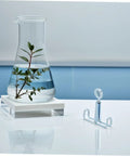 Glass beaker with plant beside 25 Piece Laboratory Rubber Tube Clamps For Flow Control With Spring Loaded Latex Hose Water Stop Clips