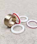 Seal assembly for HP waterjet cutting machine; brass housing with 0.875 in bore and white/red gaskets (front view)