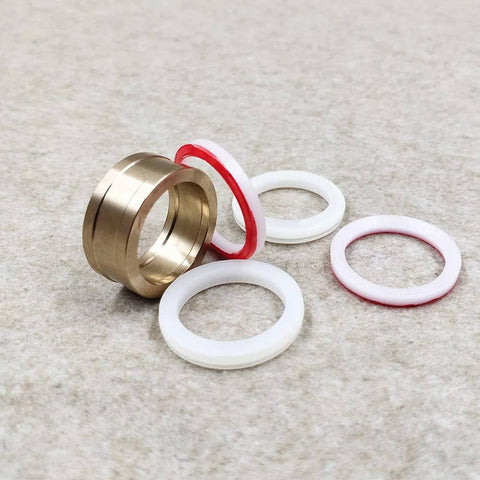 Seal assembly for HP waterjet cutting machine; brass housing with 0.875 in bore and white/red gaskets (front view)