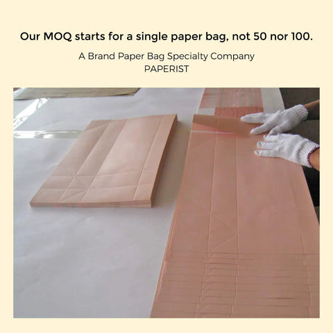 Custom White Paper Bags 100 Pack With Logo Printing 21.7x6.1x15.7 Inches 250G Thick Paper 1 Inch Color Handles flat on table