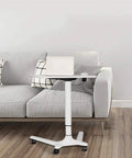 Rock Solid Rolling Laptop Cart With Height Adjustable Standing Desk And Smooth Glide Wheels For Bed Sofa Gaming Or Home Office Flex Setup, white mobile desk beside a grey couch.
