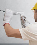 Worker using Rugged Concrete Crack Width Gauge Ruler 0.1 to 7.0 mm Dual Metric Polycarbonate on concrete wall for structural check.