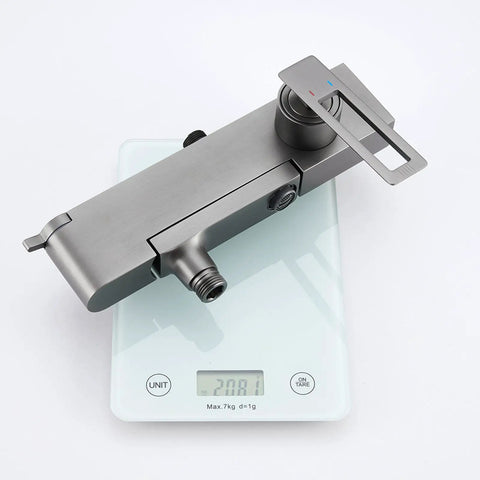 Wall Mounted Exposed Shower System with Tub Spout 90° Rotating Gun Gray faucet on a digital scale showing 20.81 kg.