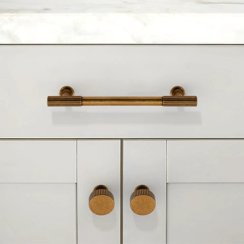 Slick Antique Brass Cabinet Knobs Two Pack Single Hole Round Drawer Pulls For Kitchen Cupboards And Dressers mounted on cabinet doors.