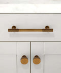 Five Pack Antique Brass Cabinet Knobs and Round Single Hole Pulls on white kitchen drawer for hardware upgrade