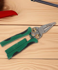 Rock Solid Multi Function Wire Strippers With Voltage Tester And Cutters on wooden surface, showcasing stainless steel and non-slip grip.