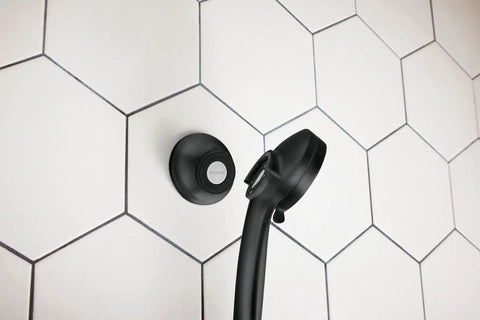 Remote Dock For Magnetix Handshower In Matte Black With Wall Bracket Or Waterproof Adhesive, shown on tiled wall