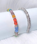 Colorful bracelet with butterfly charm and 200 Pcs Crystal Rondelle Spacer Beads 8mm Silver Plated for Jewelry Making on white surface.