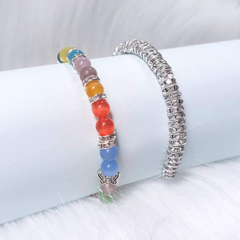 Colorful bracelet with butterfly charm and 200 Pcs Crystal Rondelle Spacer Beads 8mm Silver Plated for Jewelry Making on white surface.