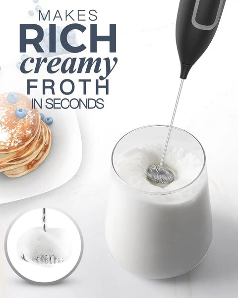 Handheld Frother Battery Powered Foam Maker Wand With Stainless Steel Whisk creating froth in a glass of milk