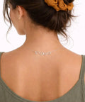 Woman wearing a necklace with Set Of 4 S Hook Necklace Extenders With Gold And Silver Swirl Hooks Durable Metal Jewelry Extenders For Necklaces And DIY Crafting Tarnish Resistant S Shaped Connectors shown from back