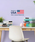 Heavy Duty Clear Plastic Storage Bins With Lids 6 Pack 4 Quart Polypropylene on a desk with craft supplies and yarn balls.