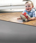 Premium Underlayment For Luxury Vinyl Laminate And Hardwood Floors Beat The Noise Sound Pad used under a toddler playing on hardwood.