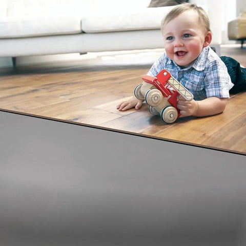 Premium Underlayment For Luxury Vinyl Laminate And Hardwood Floors Beat The Noise Sound Pad used under a toddler playing on hardwood.