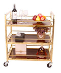 Slick Rolling Three Shelf Bar Cart with wine, glasses, apples, and flowers on a gold metal serving trolley.