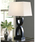 Amasai Contemporary 29 Inch Sculptured 3-Way Table Lamp Set of 2 in Black with Resin Base and Rectangular Hardback Shade on table.