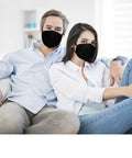 Couple wearing Kn95 Face Masks 50 Pack Individually Wrapped Five Layer Protective Respirators For Adults Men Women Indoor Outdoor Use Black