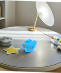 5 Piece Hollow Out Pigeon Injection Holder with buckle on a modern table near lamp