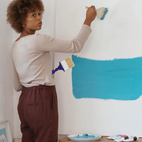 Woman painting wall with Three Inch Adjustable Flat Tip Paint Brush With 270 Degree Rotatable Head For Edge To Edge Coverage