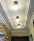 Dope Industrial Semi Flush Mount Ceiling Light Featuring A Sick Black Cage Design And Rustic Vintage Vibe Perfect For Compact Rooms With Easy E26 Led Compatibility And Badass Farmhouse Decor Accents, three lights in a hallway.