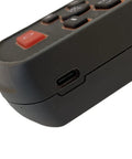 Close-up of handheld nuclear radiation and electromagnetic detector with large digital display for onsite construction use, USB port visible.