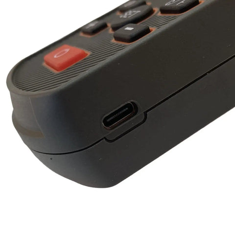 Close-up of handheld nuclear radiation and electromagnetic detector with large digital display for onsite construction use, USB port visible.