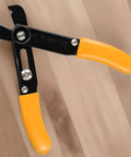 Adjustable Wire Stripper For 10-22 Awg Heavy Duty Manual Cable Cutter With Induction Hardened Edge Precision Stripping Tool For Electrical Wiring Jobs Orange And Black 130Mm Handle Design on wooden surface.