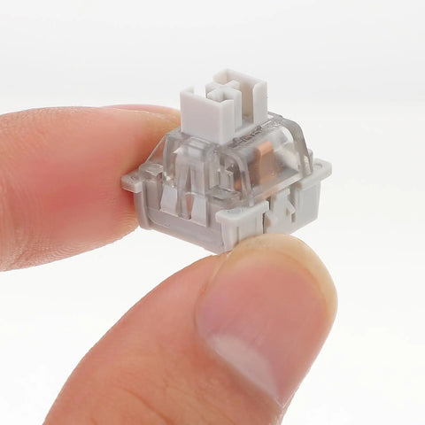 10 Pack Linear Switch Stems For Mechanical Keyboard Mods featuring a gray POM switch stem held between fingers.