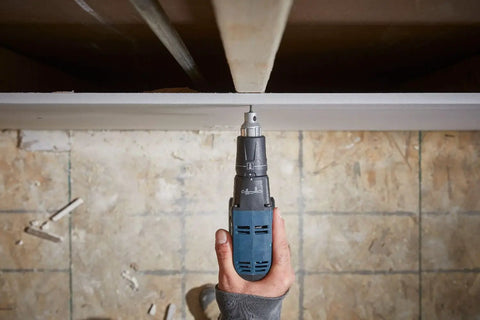 Auto Feed Attachment For GTB18V-45 Screwgun in use on drywall from overhead view