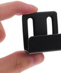 Heavy Duty Black Stainless Steel Tile Display Hangers, close-up of a wall mount hook held between fingers for mirrors and shelves.