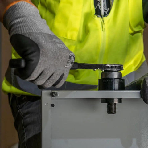 Worker using Optimized Knockout Punch Set For Ten Gauge Mild Steel With Three Quarters Inch Die Makes Wrenching A Breeze