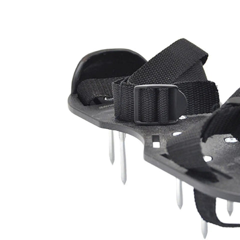Close-up of Lawn Aerator Shoes 2 Pack For Grass With One Point Six Five Inch Spikes showing adjustable strap and plastic sole.