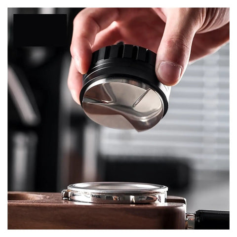 Premium Coffee Distributor And Tamper Leveler For Home Baristas held above a portafilter, showcasing its angled edges for leveling coffee grounds.