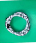 Garment Steamer Hose With High Temperature Resistant Steam Tube coiled on a green background.