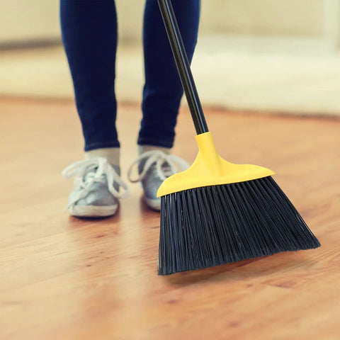 Person using 3 Pack 54 Inch Heavy Duty Rugged Outdoor Brooms With Four Layer Stiff Bristles For Pro Grade Commercial Indoor Outdoor Use In Courtyard