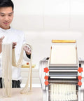 Chef showing fresh noodles made with Compact Automatic Electric Pasta Maker For Fresh Homemade Noodles Stainless Steel Kitchen Press.